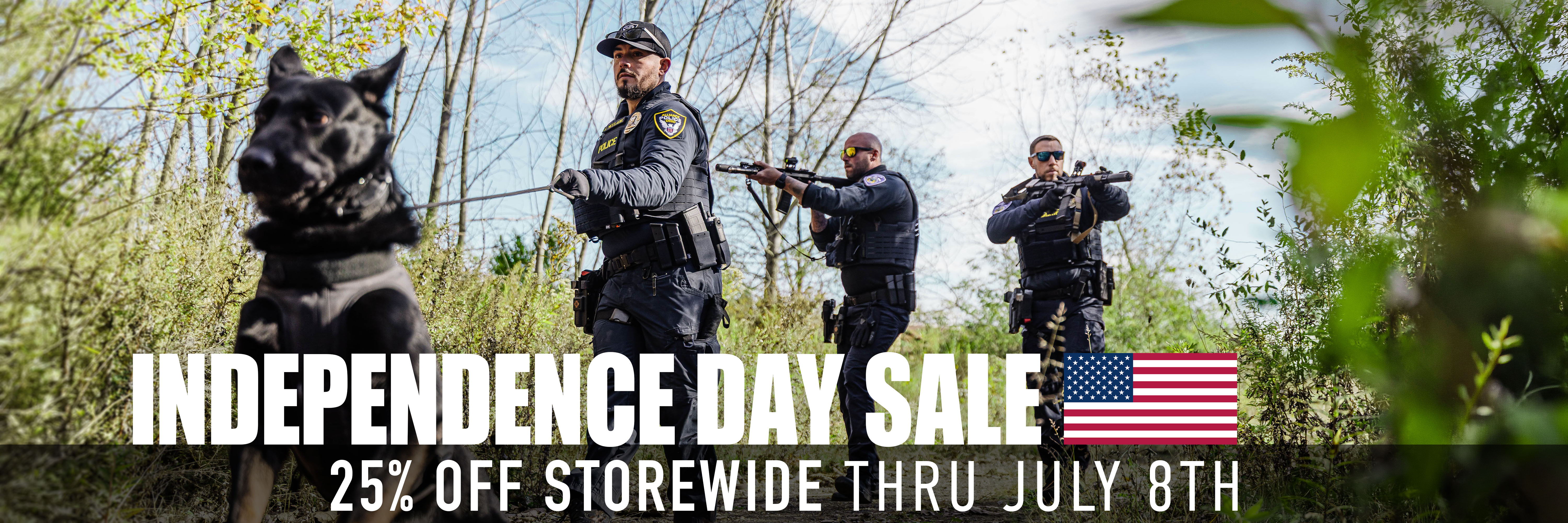 Independence Day Sale with police officers and a dog in a forested area.