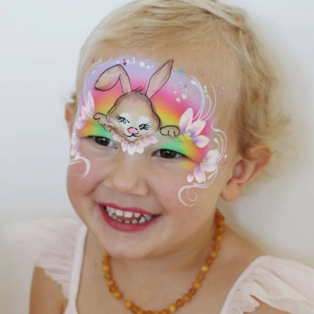 cute easter bunny girl with rainbow and flowers face paint