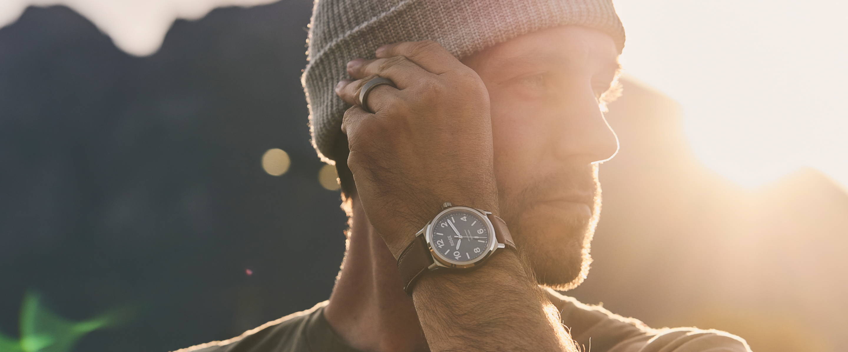 man fixing his beanie while showing his Ridge Field Watch