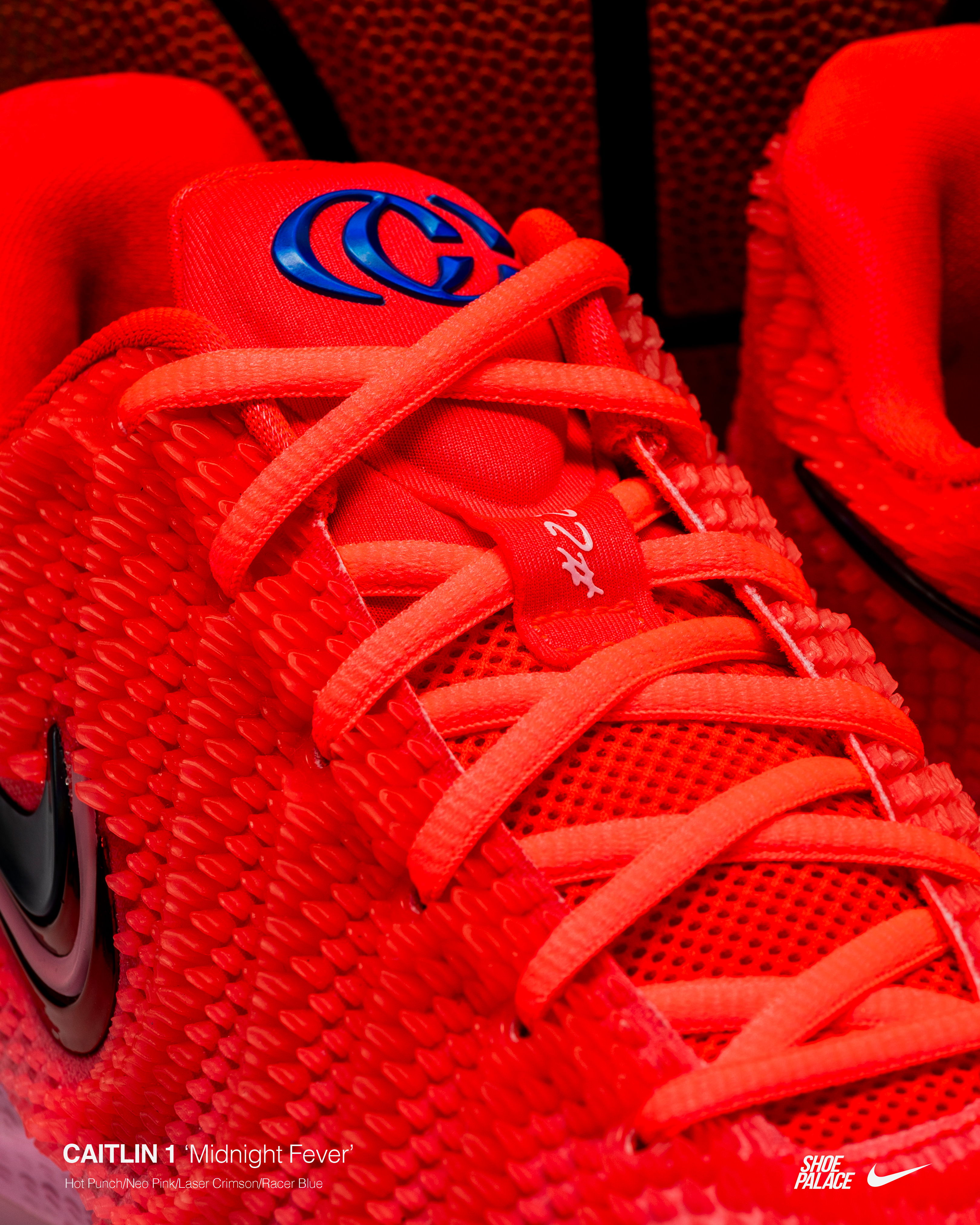 Close-up of red athletic shoes with laces and logo.