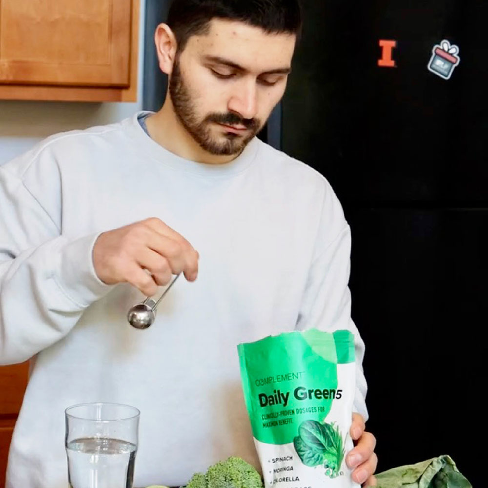 Man preparing his daily greens drink