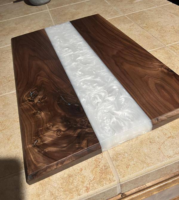 An epoxy tray with a white-pigmented river vein of resin.
