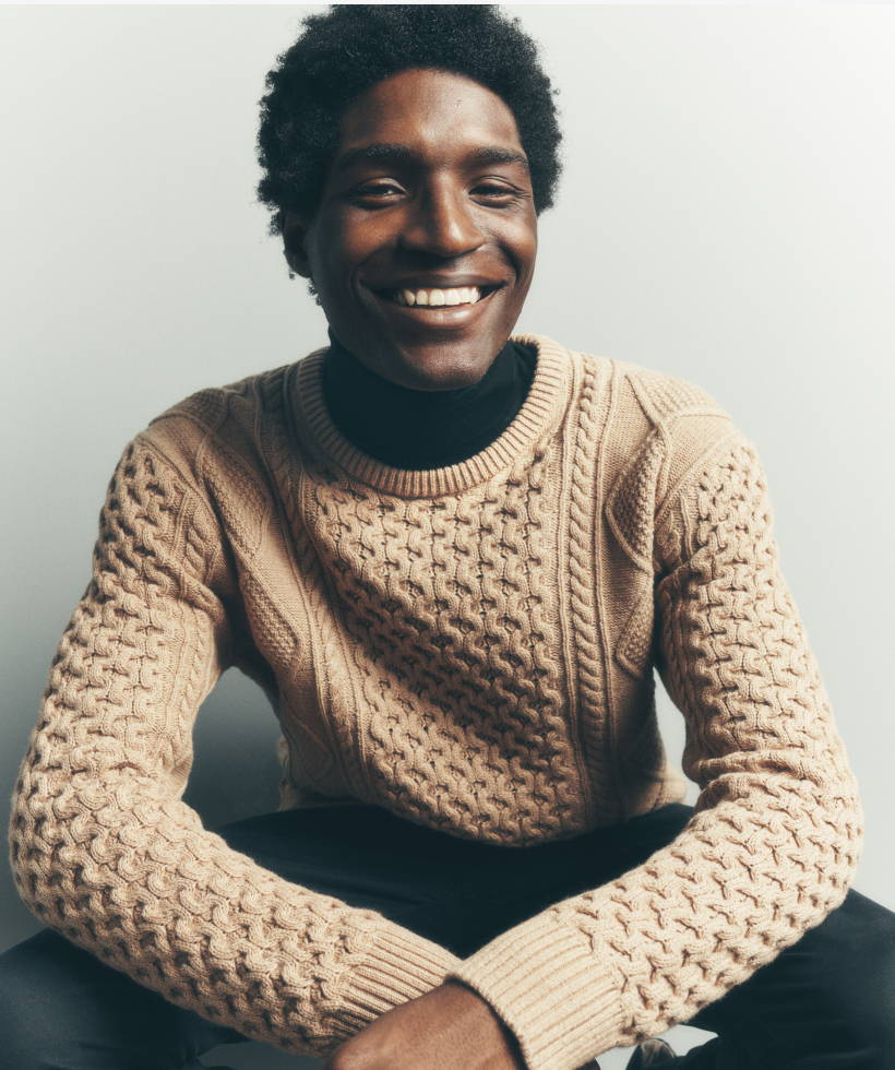 Model is wearing UNTUCKit Cable Knit Crewneck Sweater. 