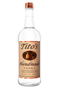 Clear bottle of Tito's Handmade Vodka with a copper cap.