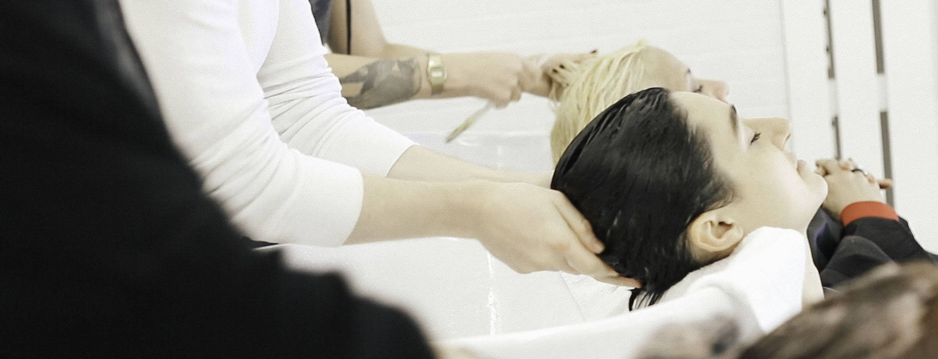 stylists hands shampooing clients in the sink