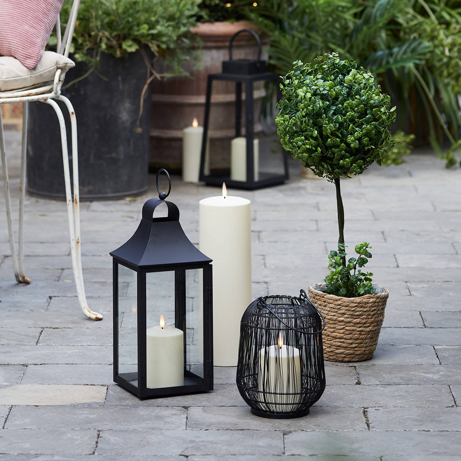 Garden lanterns and candles on a patio