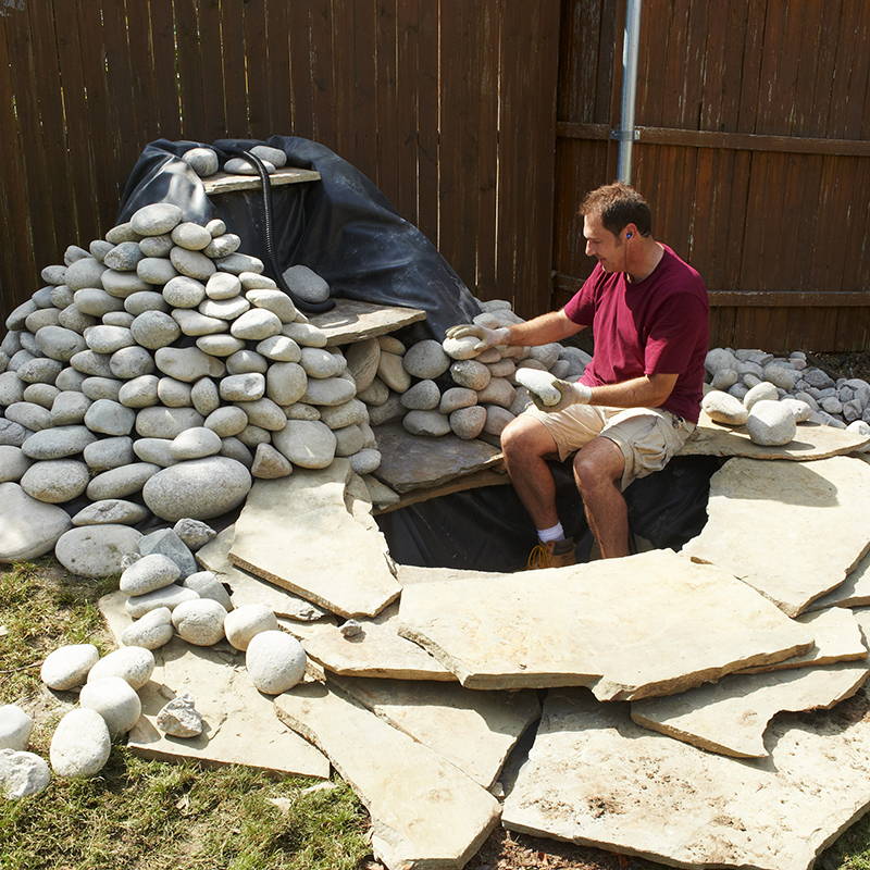 use smooth landscaping stone to cover the waterfall