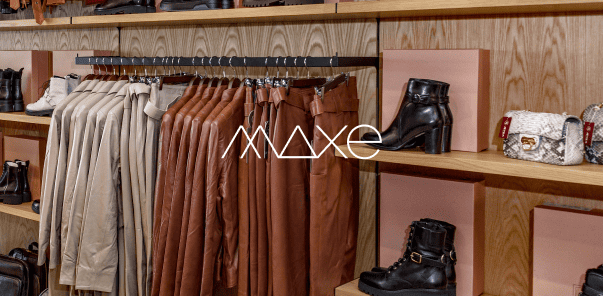 Clothing and shoes displayed on wooden shelves in a retail store.