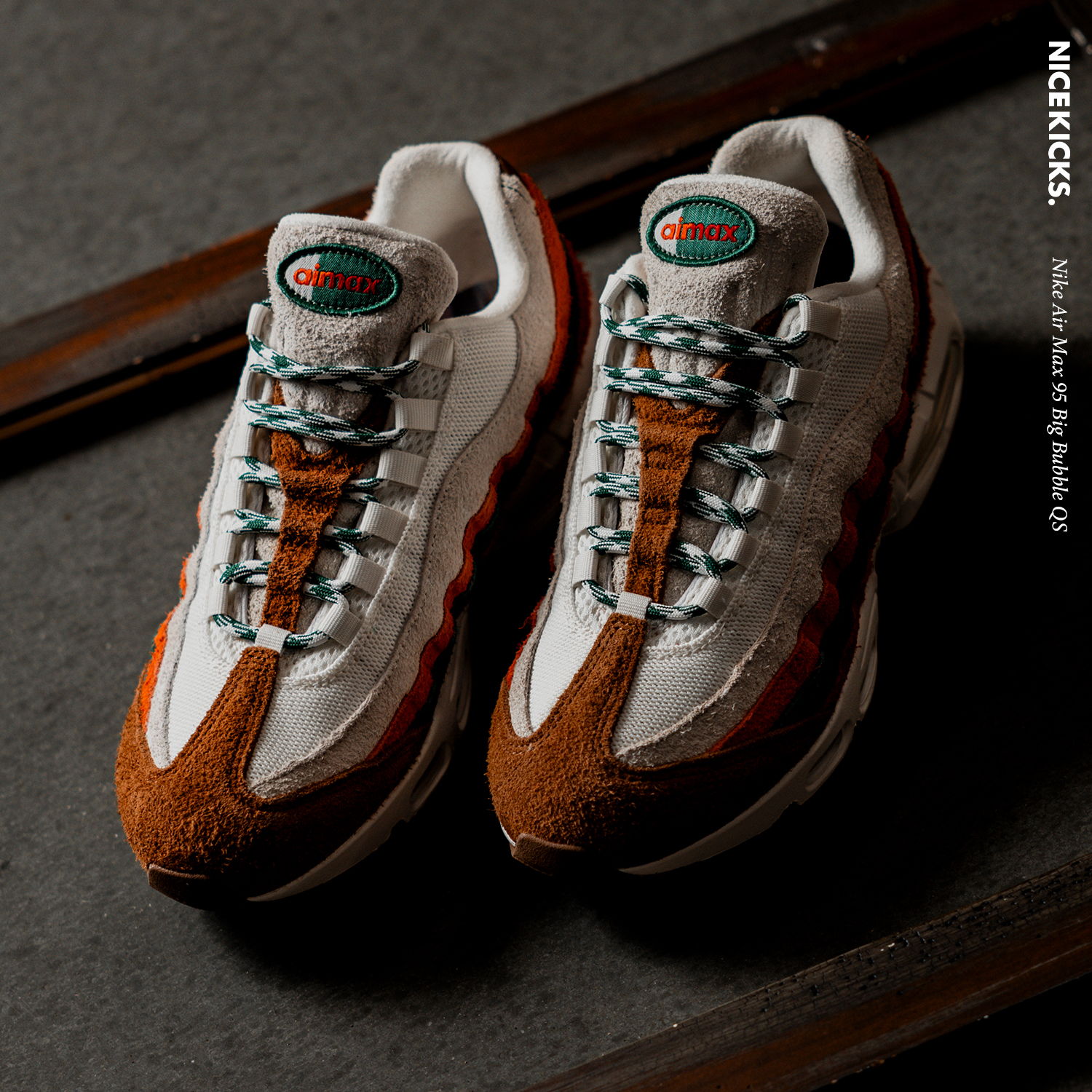A pair of stylish sneakers on a dark surface.