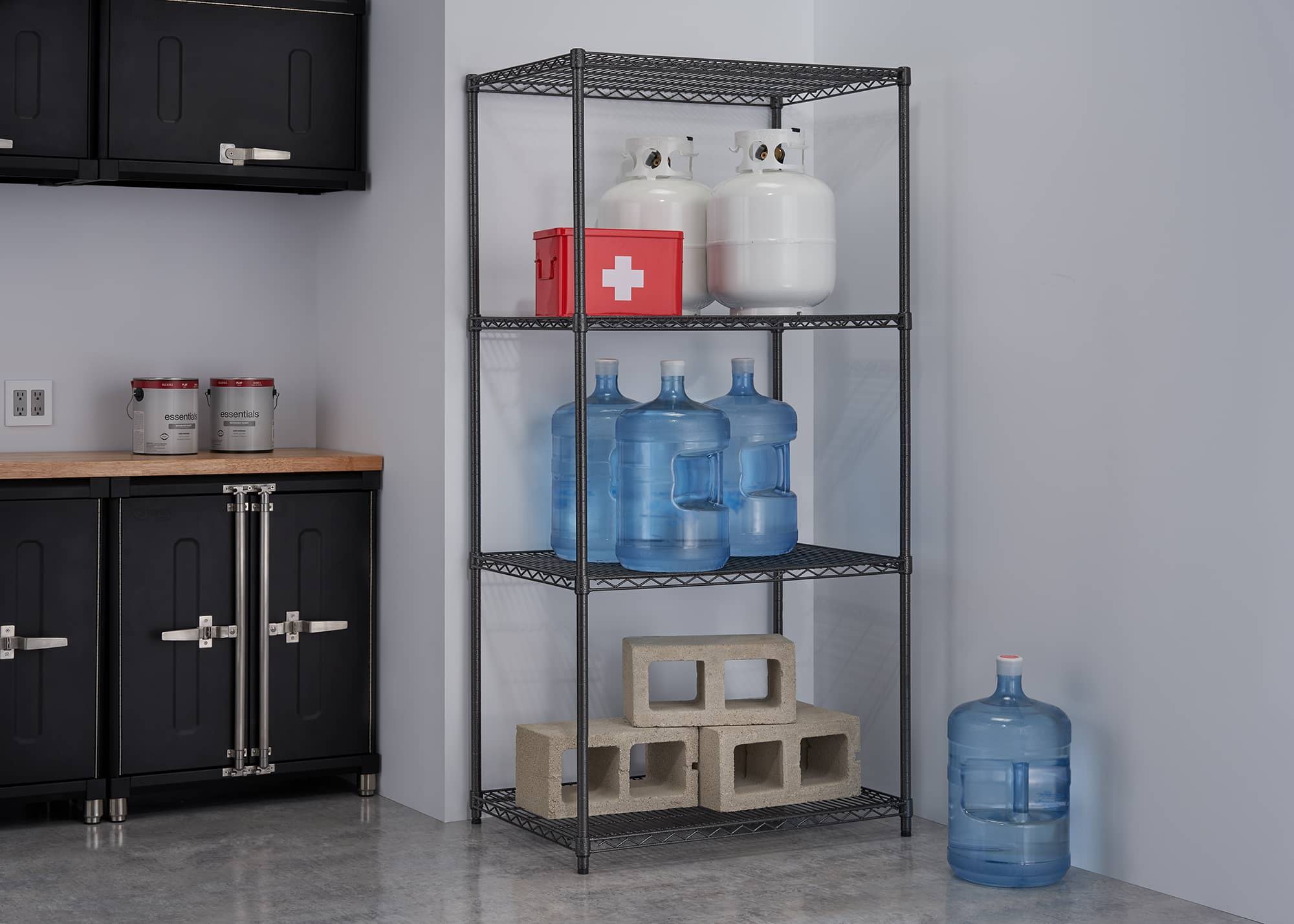 heavy duty wire shelving rack filled with water jugs and concrete blocks
