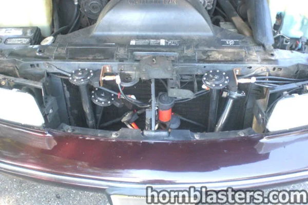 Engine bay front grille four black train horn trumpets solenoid valve Jack's 1996 Chevy Caprice Conductor's Special 232 HornBlasters customer install gallery photo 2