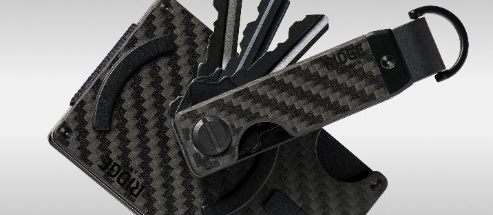 A collection of black carbon fiber key organizers and a keychain.