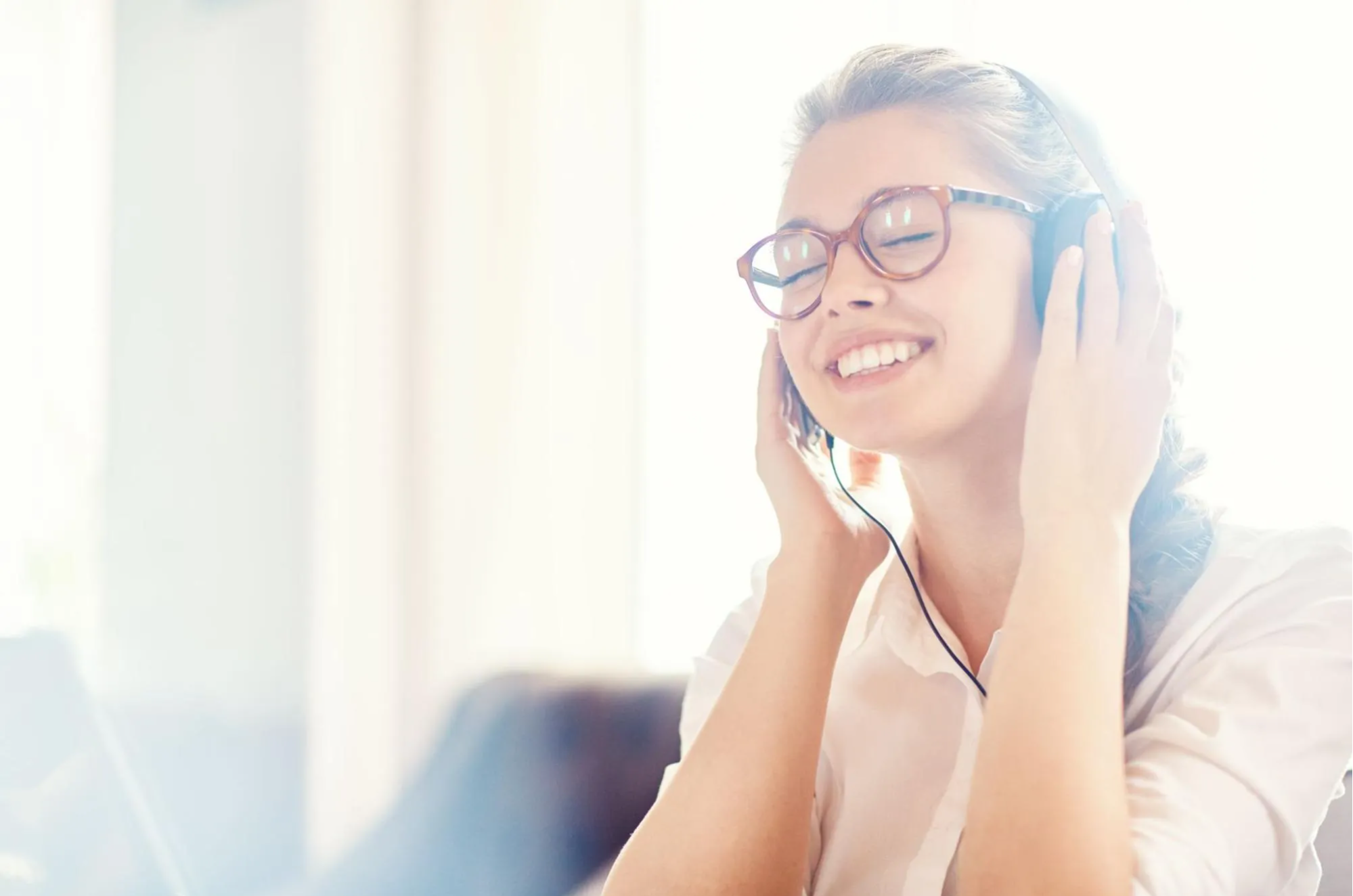 woman listening to music through headphones
