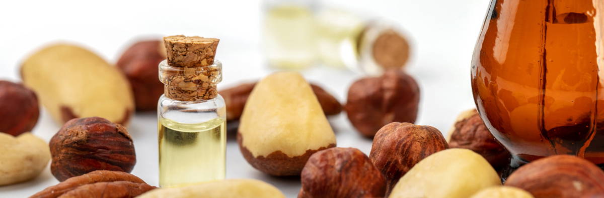 A close up of oils and raw nuts and needs