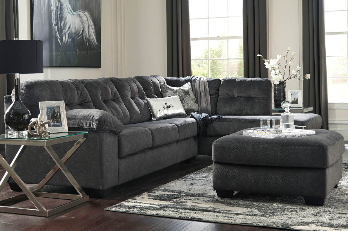 Living room with large chaise sectional and ottoman.