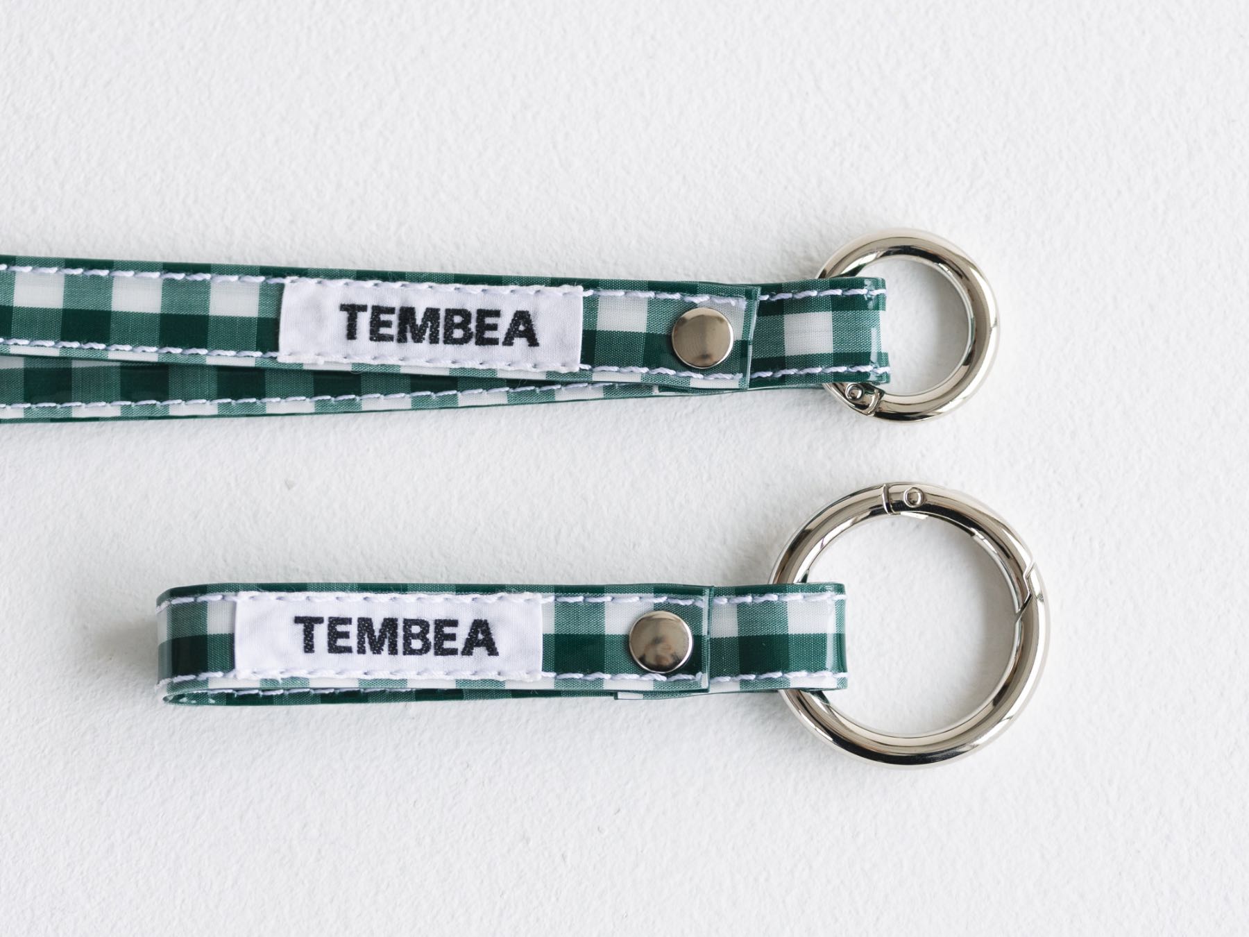 Two green and white checkered keychains labeled 