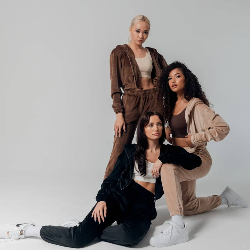 three female models wearing sacre velour collection kneeling