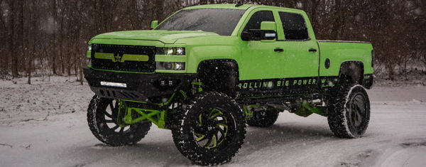 Front three-quarter view of Joe's bright green lifted 2017 Chevrolet Silverado 2500HD parked in the snow, install photo 1