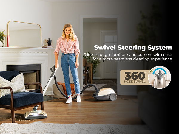 Woman using a vacuum cleaner with a swivel steering system in a living room.