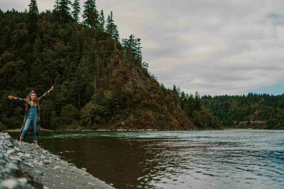 woman standing next to a river wearing outdoor sandals