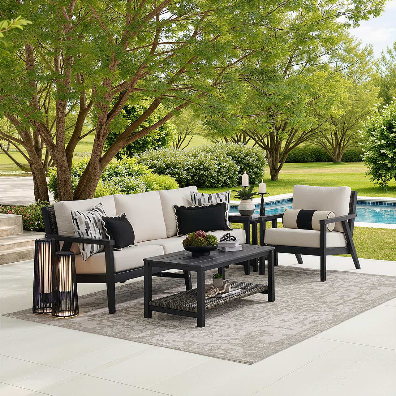 Outdoor seating area with a sofa, chairs, and a coffee table.