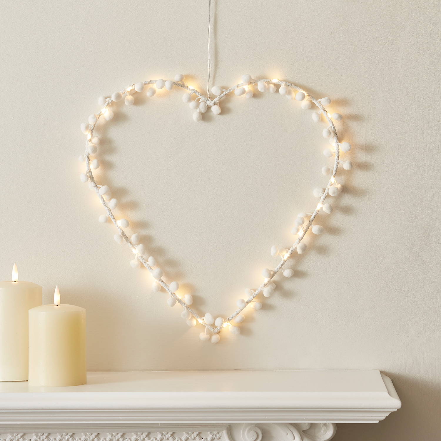 Warm white LED heart light with white pompoms.