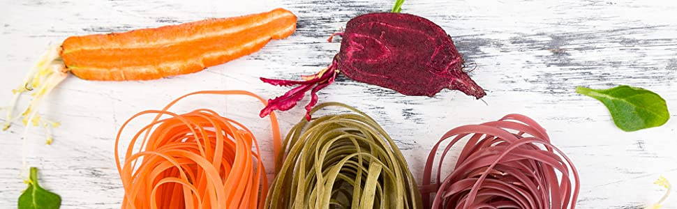 carrot pasta, spinach pasta and beet root fresh pasta on a wood table