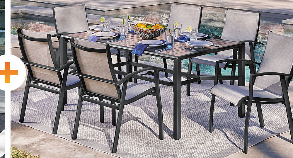 Outdoor dining set with a table and six chairs by a pool.