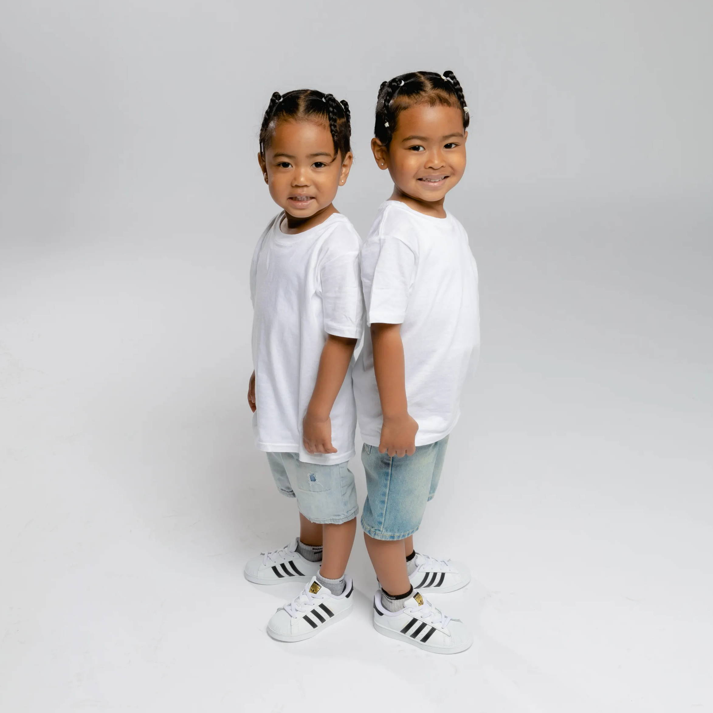 twin boys matching wearing adidas superstars
