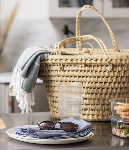 Picnic basket with napkins and sunglasses