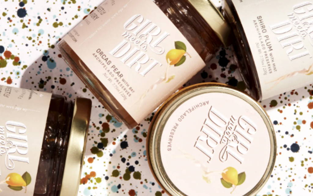 Four jars of Orcas Pear with Bay Spoon Preserves are sitting on a speckled countertop.