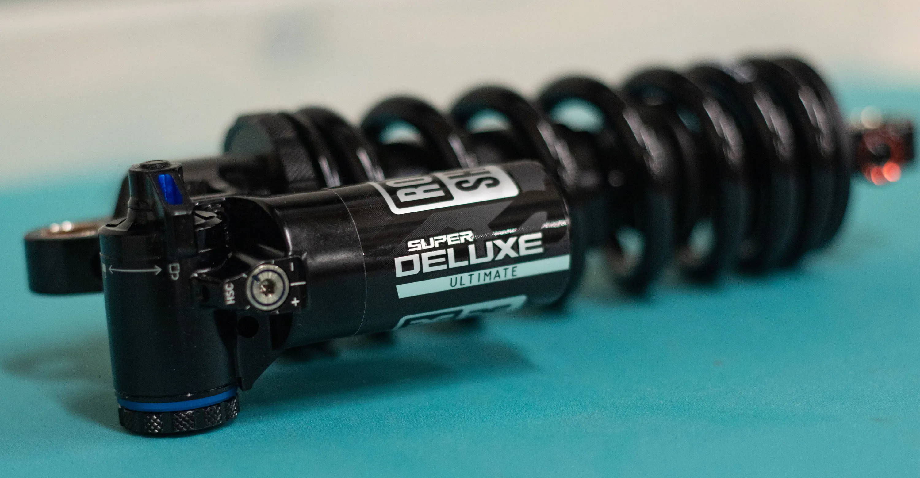 detail of the piggy back on a rockshox super deluxe ultimate coil mtb rear shock