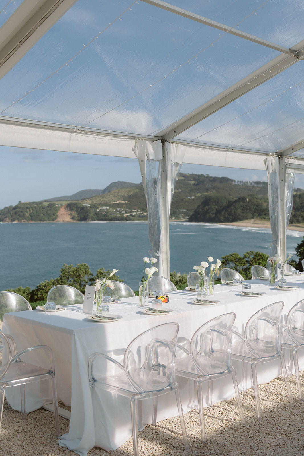 Elegant outdoor dining setup with a view of the ocean.