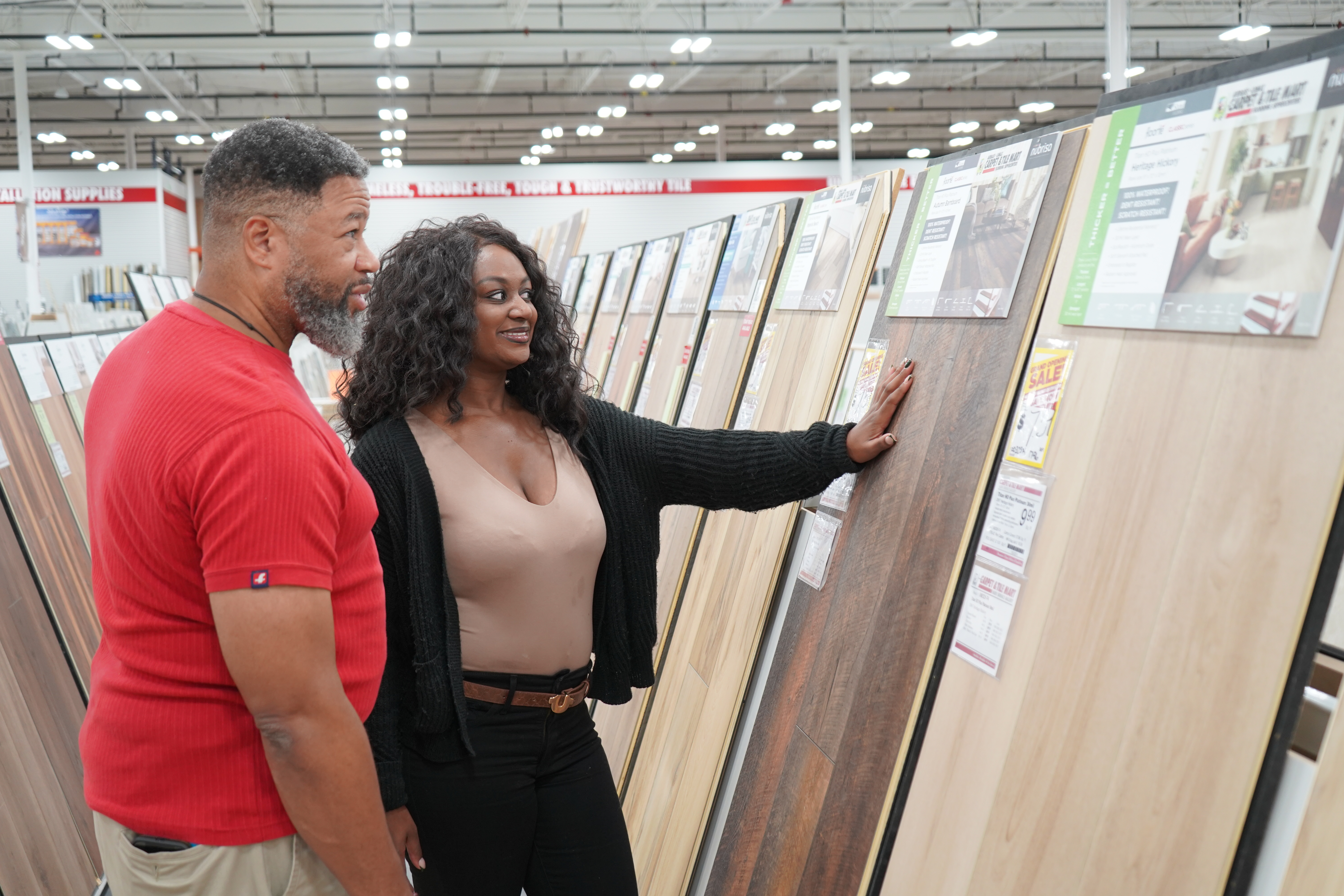 man and woman looking at hard surface flooring options