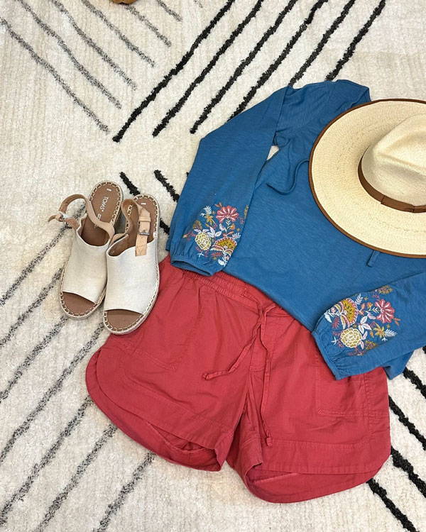 Blue Kateri long sleeve top with Parker shorts in red .