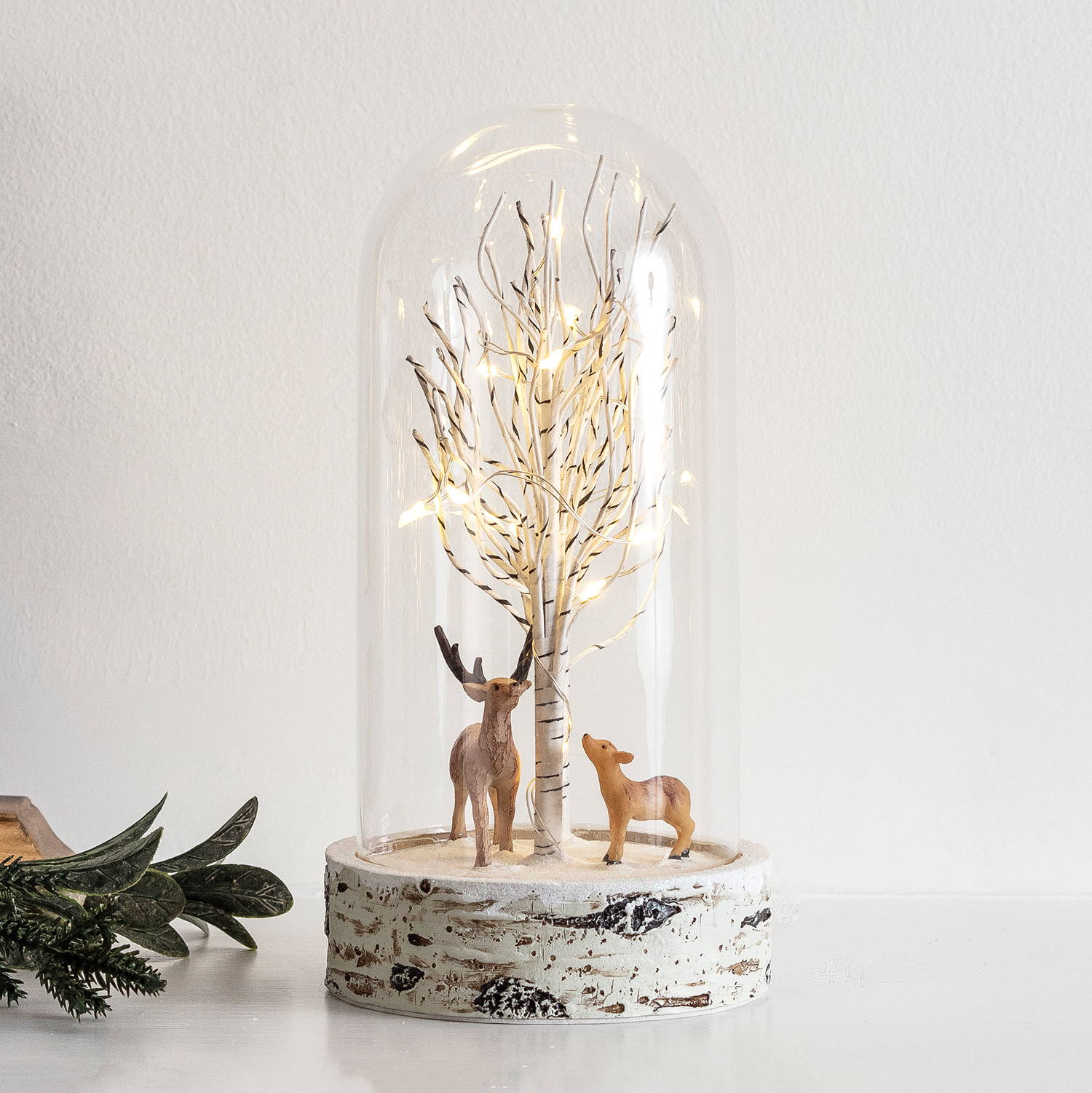 Christmas reindeer glass duo featuring a reindeer and doe under a micro light Christmas tree encased by glass