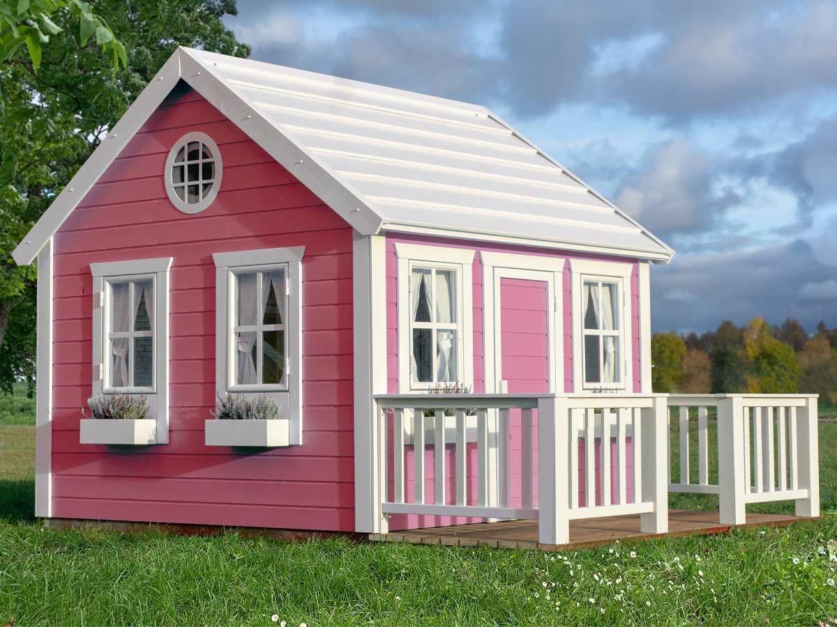 Pink wooden custom playhouse on gradd with trees and cloudy sky in the background by WholeWoodPlayhouses