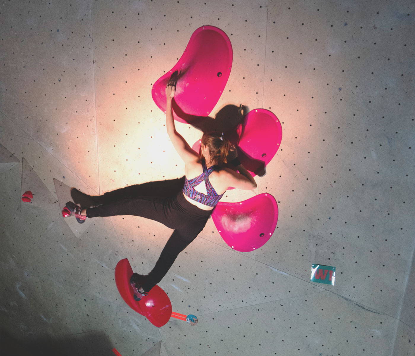 This photo shows 3RD ROCK warrior Imi doused in a spotlight when climbing at a compeition.