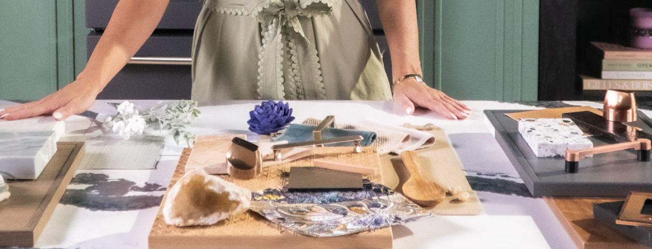 Person with hands on table displaying various materials and objects.