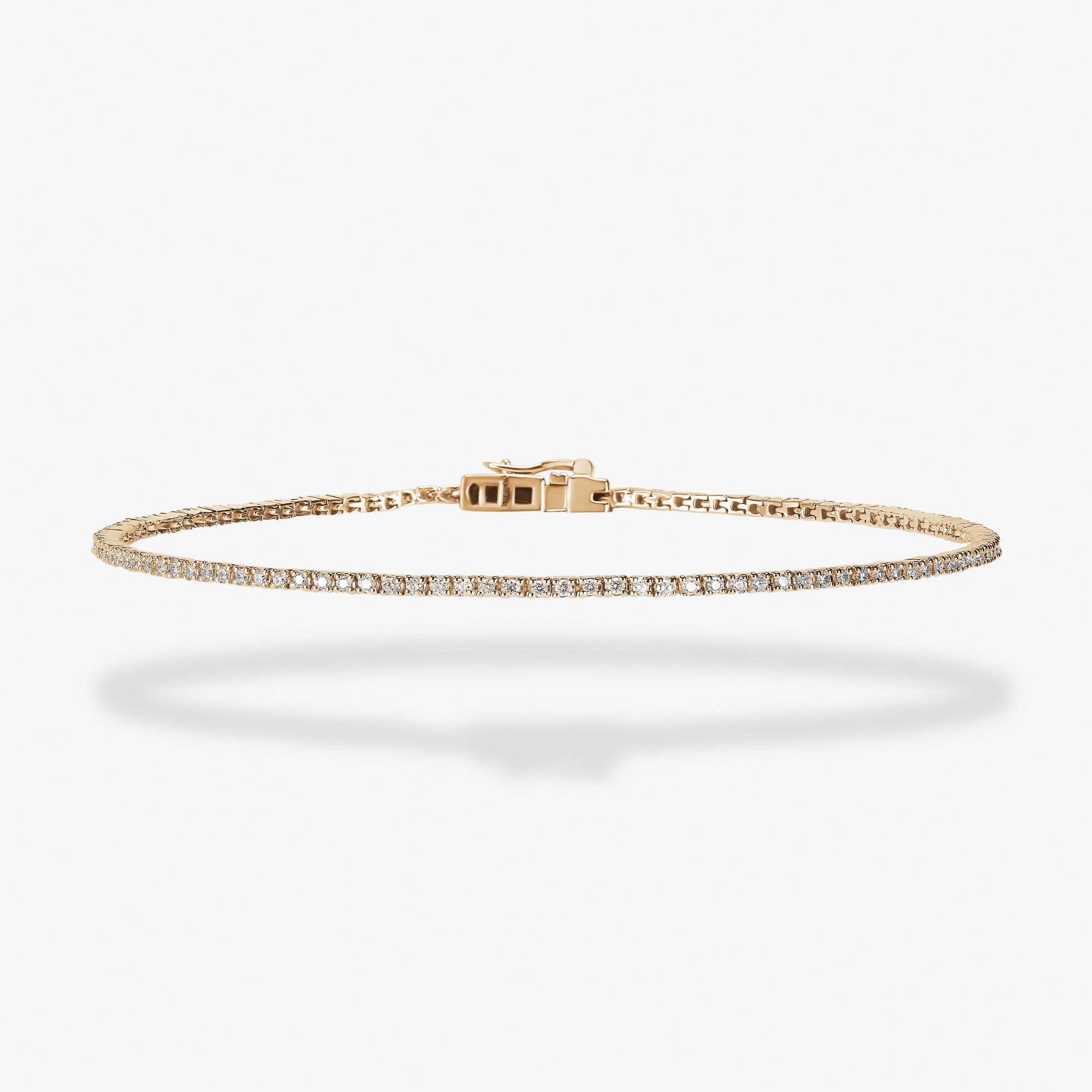 Gold bracelet with delicate design and sparkling accents on a white background.