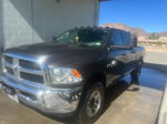 Front-left view of dark metallic Ram 2500 crew cab in car wash bay with desert mountains beyond
