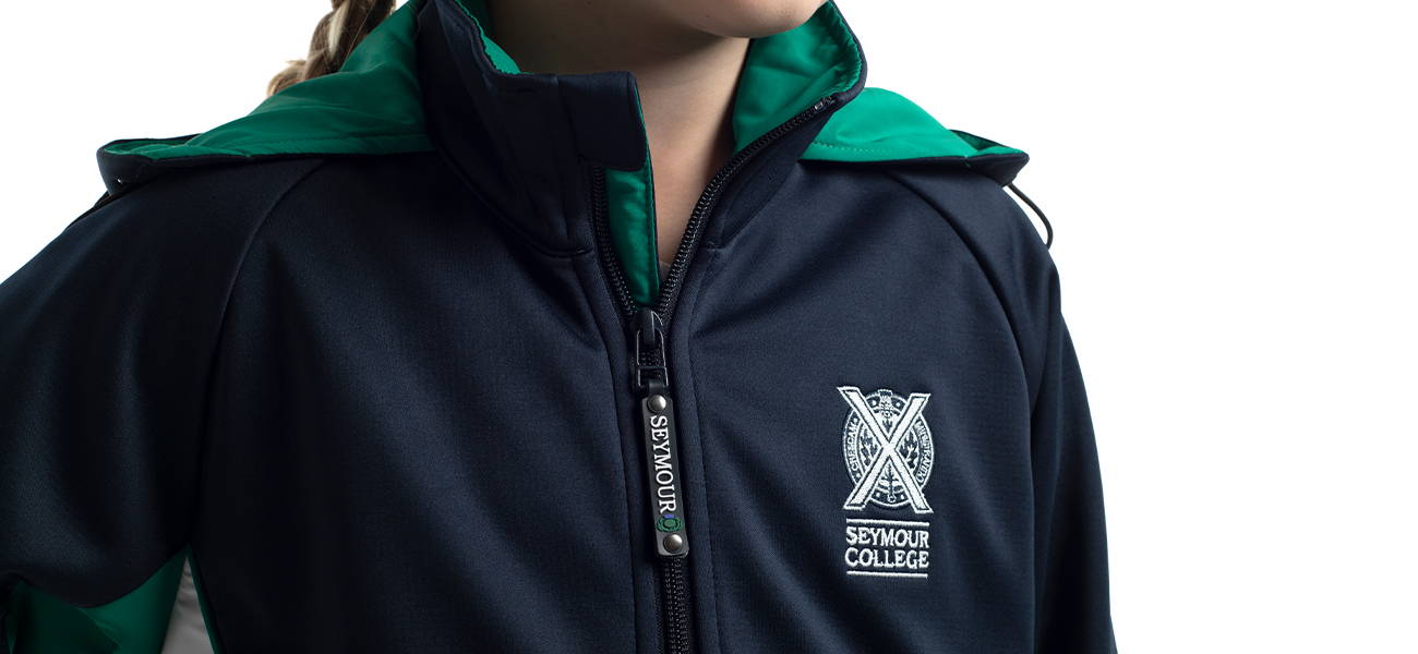 Custom softshell jacket with branded zip pull, detachable hood and embroidery for Seymour College