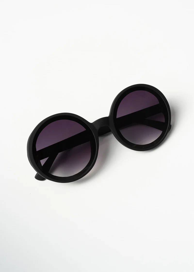 A pair of black, circular oversized sunglasses