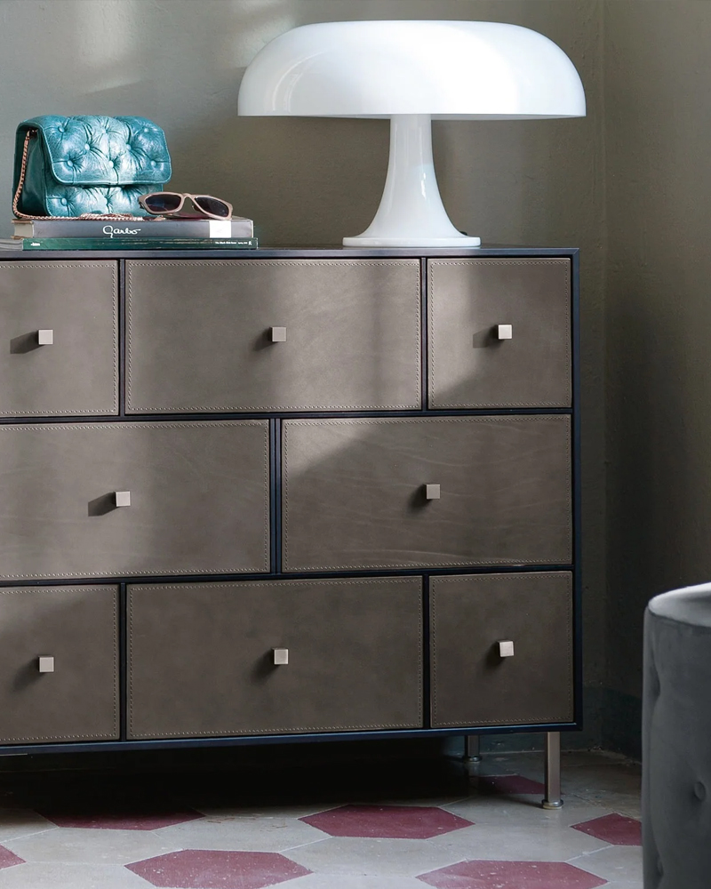 Modern Rucellai Drawer dresser with lamp and accessories on top.