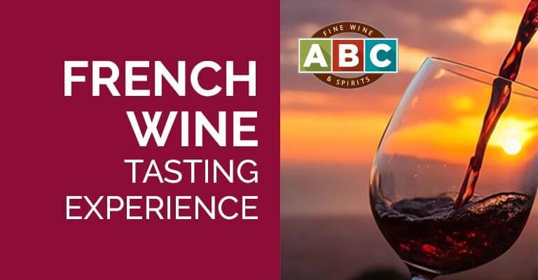 French wine tasting experience with a glass and sunset background.