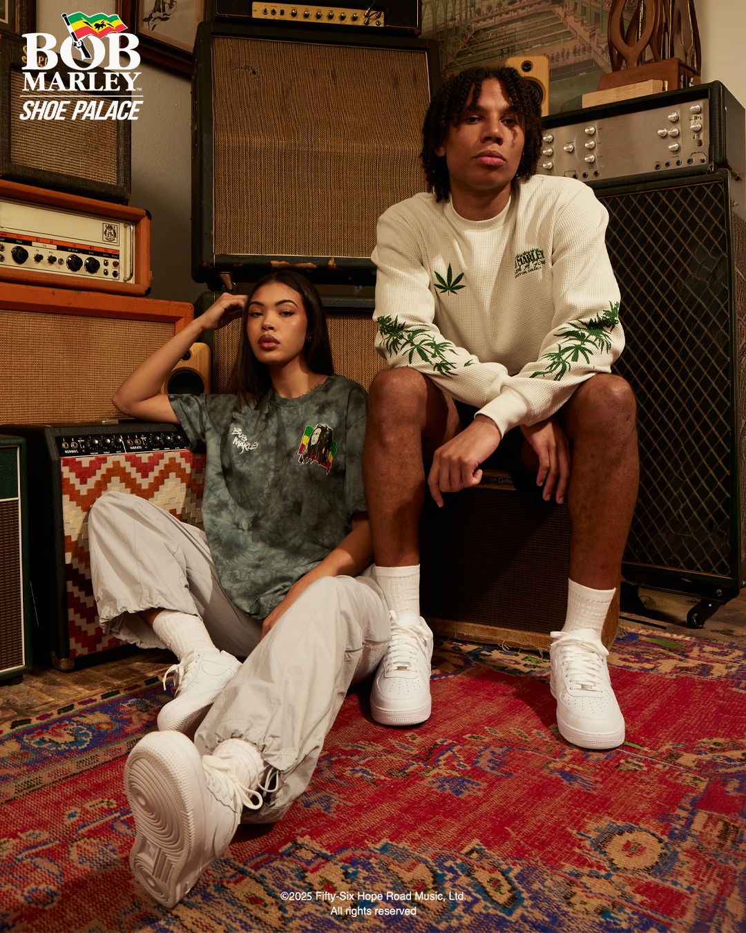 Two models posing in casual clothing in a music studio setting.