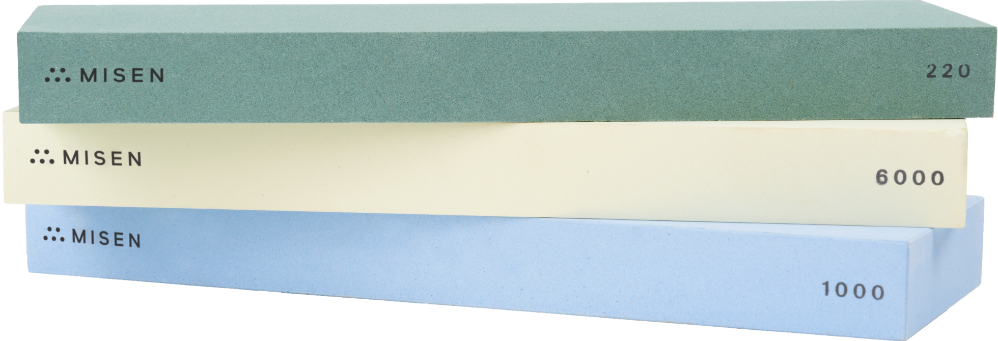 Close view of green 220-grit, blue 1000-grit, and cream 6000-grit Misen Sharpening Stones in an off-kilter stack, with Misen logo and grit numbers visible.