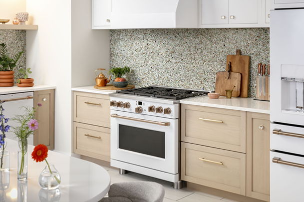 Modern kitchen with a white stove, cabinets, and decorative backsplash.