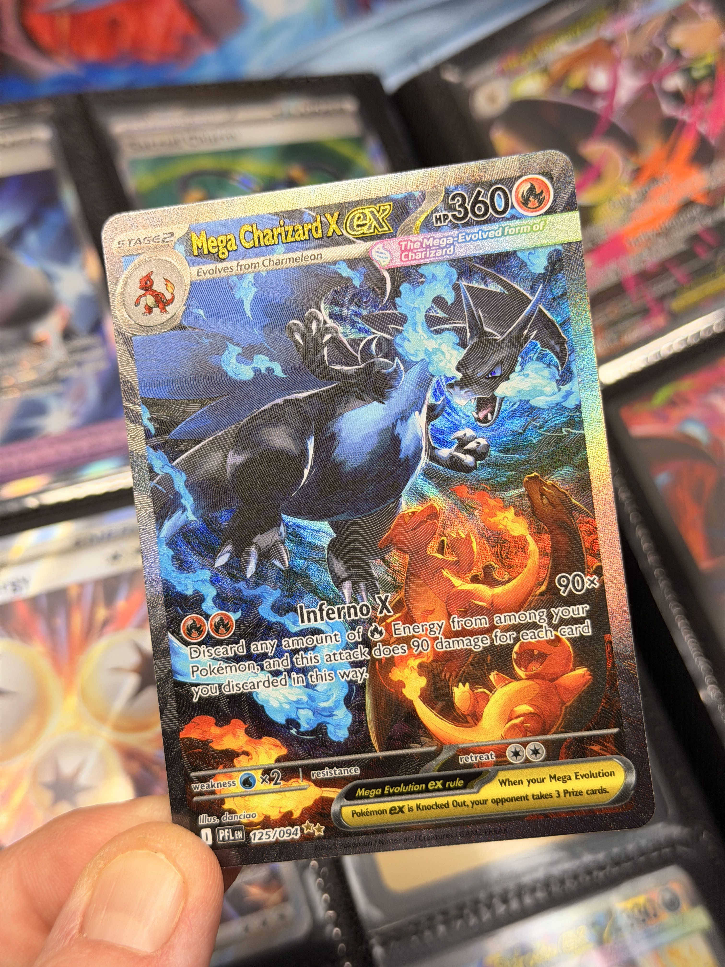 A Pokémon trading card featuring Mega Charizard X and Mega Charizard Y.