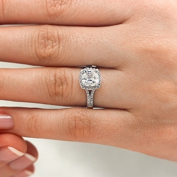 Diamond halo split shank engagement ring with diamond accented band